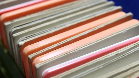 Colored plastic and cardboard frames with photographic film stand in a row one a Stock Footage 149220302