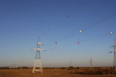 The colored plastic balls hanging on overhead electricity wires are called .. 스톡 사진