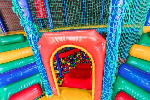 Colored plastic balls in pool of game room. Swimming pool for fun and jumping in Stock Photos