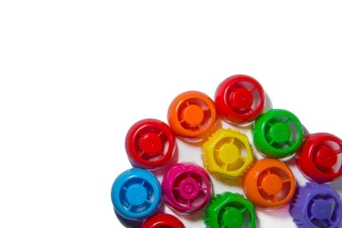 Colored Plastic corks from bottles on a white background. The pollution of Ea 스톡 사진