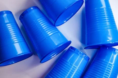 Colored plastic cups lie next to each other, background Stock Photos