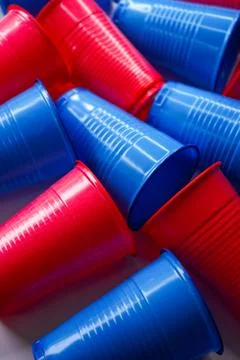 Colored plastic cups lie next to each other, background Stock Photos