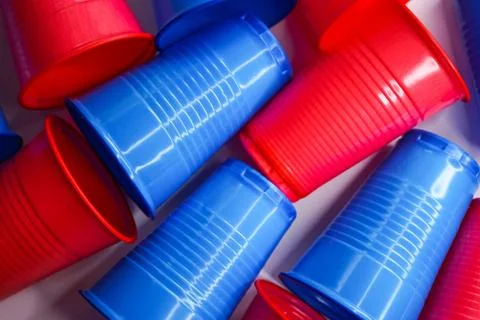 Colored plastic cups lie next to each other, background Stock Photos