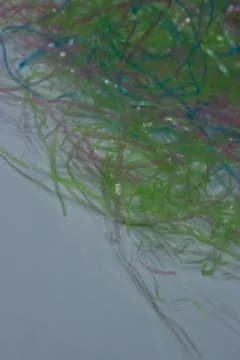 Colored plastic easter grass on a white background Stock-Fotos