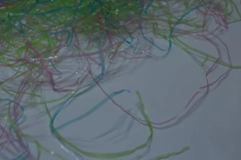 Colored plastic easter grass on a white background Stock Photos