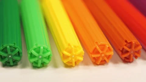 Colored plastic felt-tip pens arranged of rainbow colors lie on white table Video stock 312071732