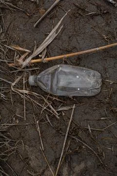 Colored plastic garbage, plastic tableware in the grass, environmental pollution Stock Photos