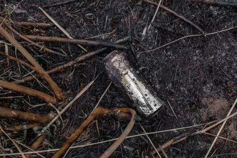Colored plastic garbage, plastic tableware in the grass, environmental pollution Stock Photos