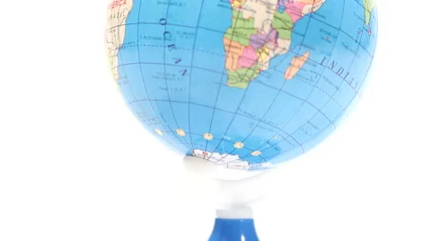 Colored plastic globe. Tilt from white background over Africa 動画素材 60250012