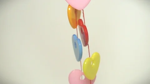 Colored plastic hearts on a rope Stock Footage 99476968