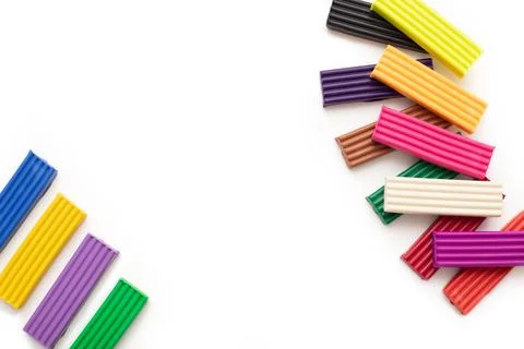 Colored plasticine modelling clay pieces, sticks on isolated white background Stock Photos