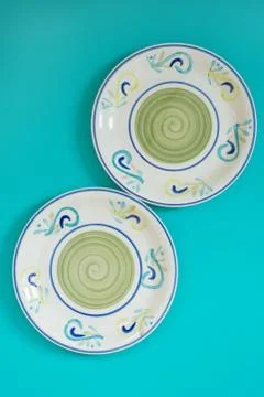 Colored plates on turquoise background Stock Photos
