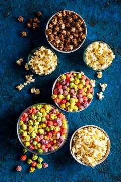 Colored popcorn in box on blue background top view copy space Stock Photos