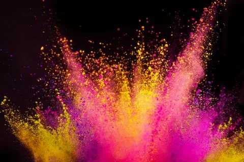 Colored powder explosion on black background. Stock Photos