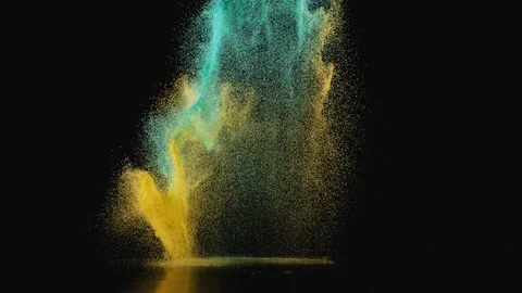 Colored powder/particles fly against black background. Slow Motion. Stock Footage 89596385