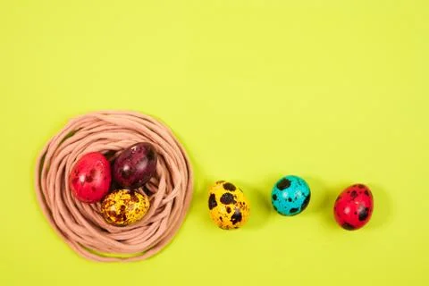 Colored quail eggs in the nest. Easter Stock Photos