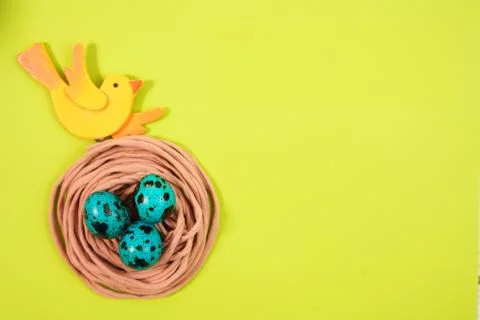 Colored quail eggs in the nest. Easter Stock Photos