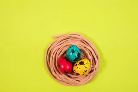 Colored quail eggs in the nest. Easter Stock Photos