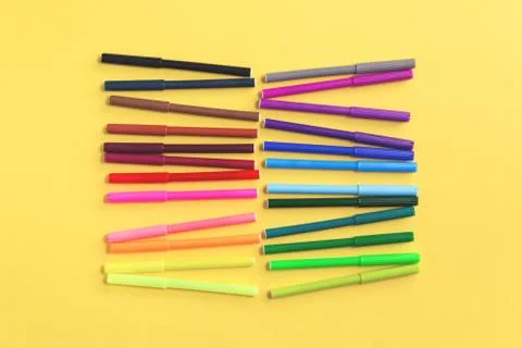 Colored rainbow gradient markers rows on yellow Stock Photos
