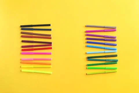 Colored rainbow gradient markers rows on yellow Stock Photos