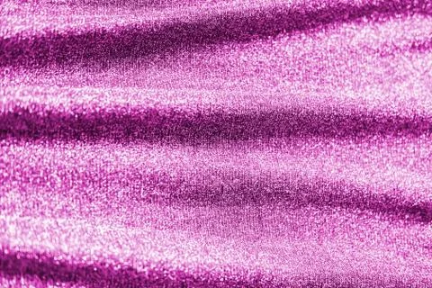 Colored raspberry pink magenta shiny fabric texture with folds. Surface backg Stock Photos