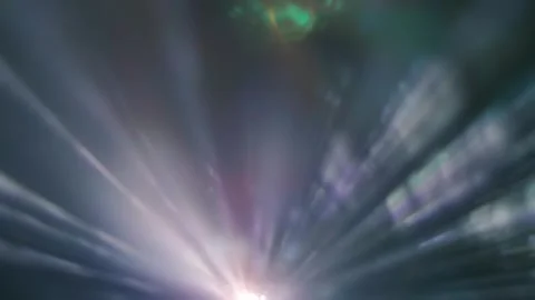 Colored rays emerge from the edge of the frame and move on a black background Stock Footage 313154607