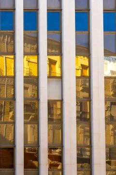 Colored reflections on the windows of the facade of a building Photos
