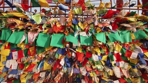 Colored ribbons and small flags with prayer flutter in wind on gates adorned Stock-Footage 240396463