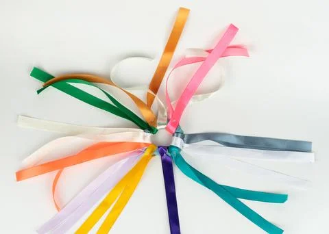 Colored ribbons in a circular pattern on a white surface Stock Photos