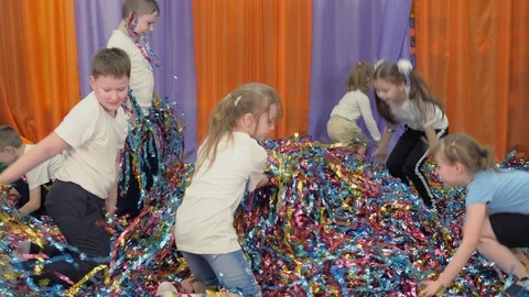 Colored ribbons fly in different directions. Woman emerges from under the Stock Footage 124919429