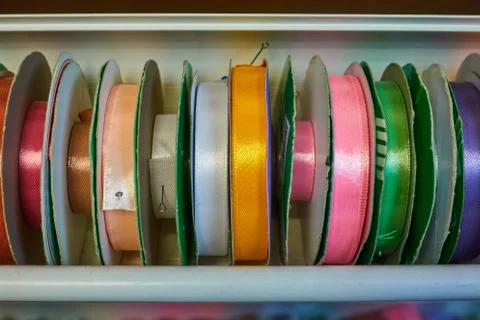 Colored ribbons for needlework on coils in the store Stock-Fotos