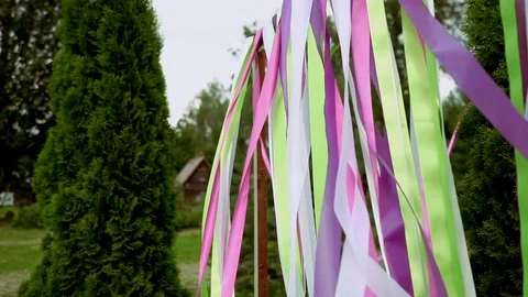 Colored ribbons on a wedding arch. Summer weather, ribbons beautifully develop Stock Footage 117134017