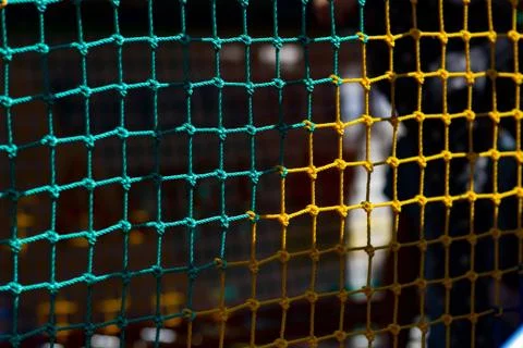 Colored rope net with a blurred background in the background. Stock Photos