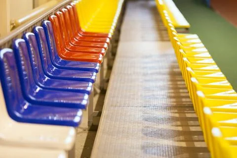 Colored seats at a stadium in the room Stock Photos