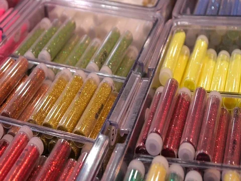 Colored sequinsin tubes for makeup. Shiny glitter on makeup. Stock Footage 73397760