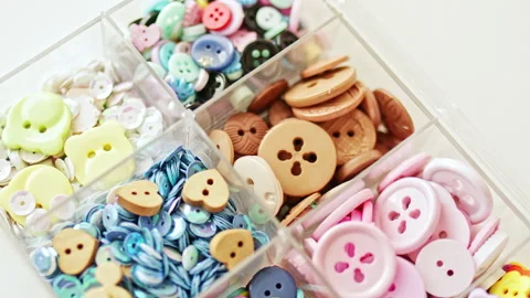 Colored sewing buttons are sorted in a box Stock Footage 231807300