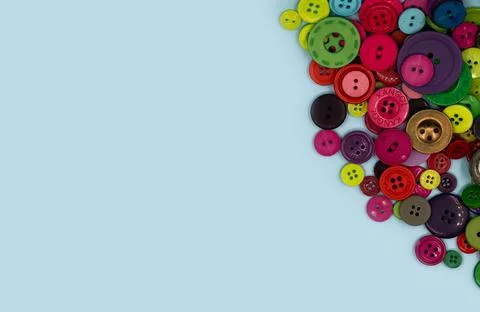 Colored sewing buttons composition on green pastel background. Flat lay with  Stock Photos