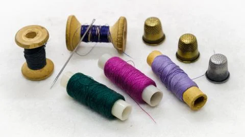 Colored sewing thread and a thimble Stock Photos