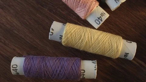 Colored sewing threads on the table Stock Footage 79512591