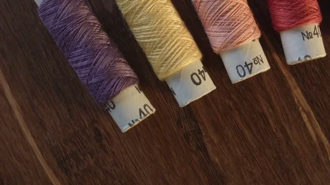 Colored sewing threads on the table Видео 79534883