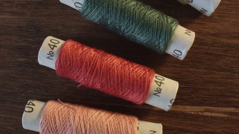 Colored sewing threads on the table Stock Footage 79537323