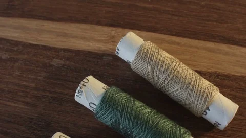 Colored sewing threads on the table Vídeo Stock 79544661