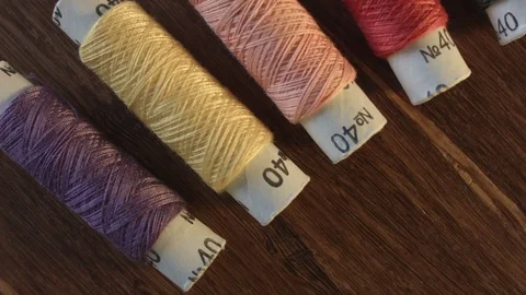 Colored sewing threads on the table Vídeo Stock 79545486