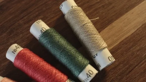 Colored sewing threads on the table Stock Footage 79547171
