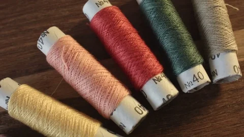 Colored sewing threads on the table Vídeos de archivo 79565699
