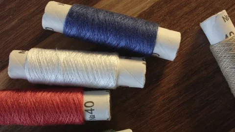 Colored sewing threads on the table Vídeos de archivo 79565924