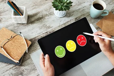 Colored smiles. Customer satisfaction control on device screen. Service and 스톡 사진