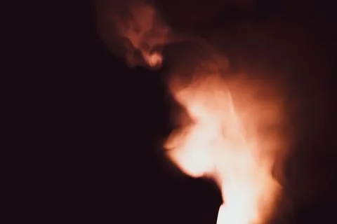 Colored smoke on black backdrop. abstract background with brown fog Stock Photos