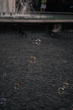 Colored soap bubbles on a dark cobblestone background Varazdin Croatia 10.07.24 Stock Photos