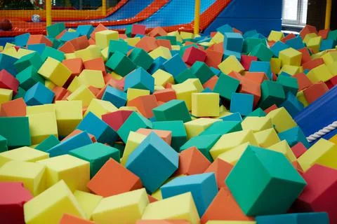 Colored soft cubes fill the dry pool for children's jumping Stock Photos